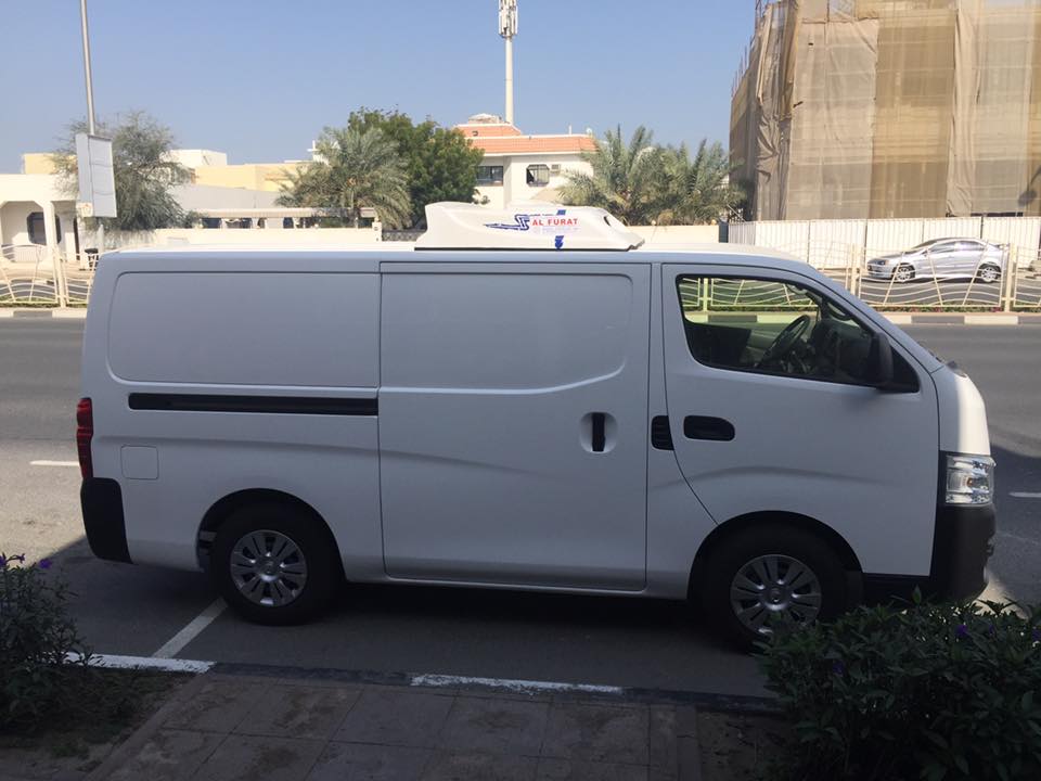 Refrigerator Transport branded chiller van on a Dubai street